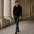 Man wearing the black Valemont sweater in a European colonnade