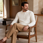 Man wearing the white Valemont sweater in a refined villa interior
