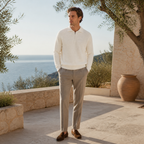 Man wearing the white Valemont sweater on a Mediterranean villa terrace