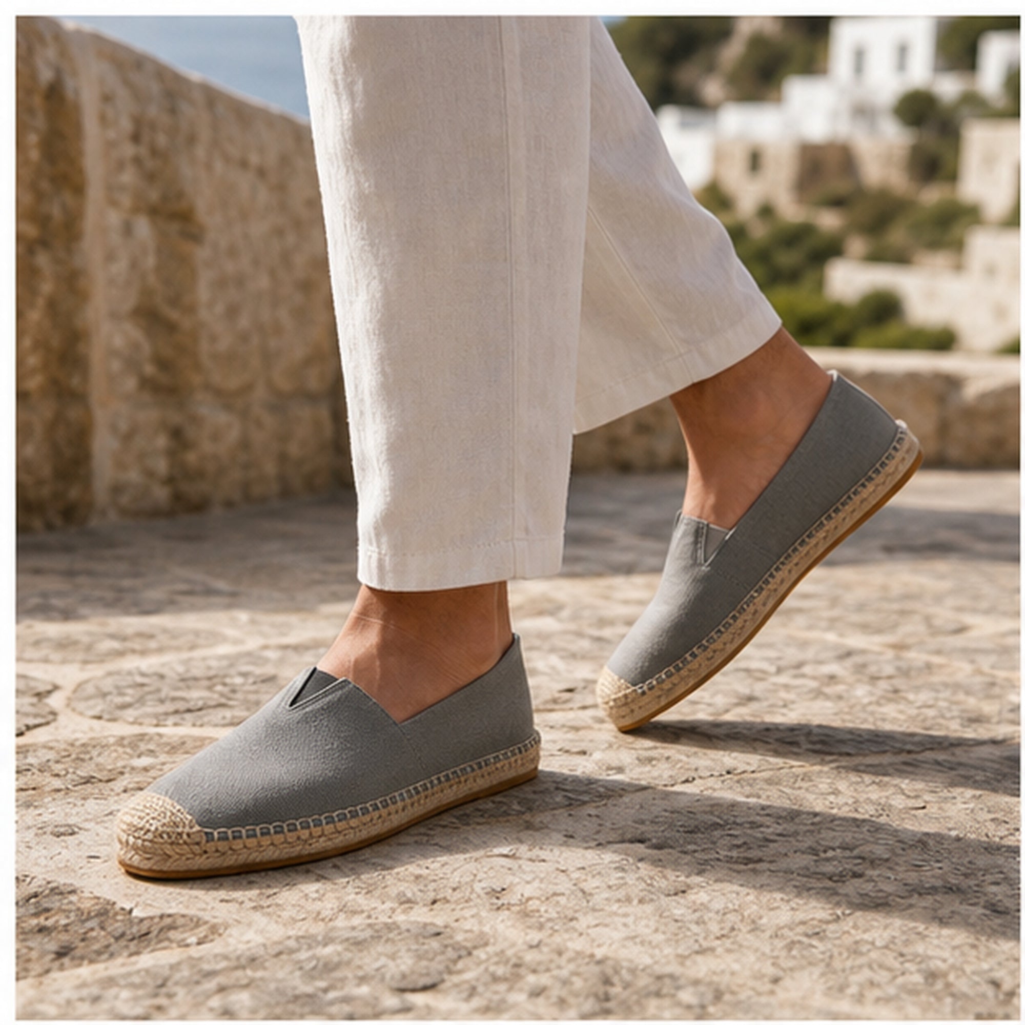 Grey Wynmont canvas espadrilles worn on a Mediterranean stone terrace