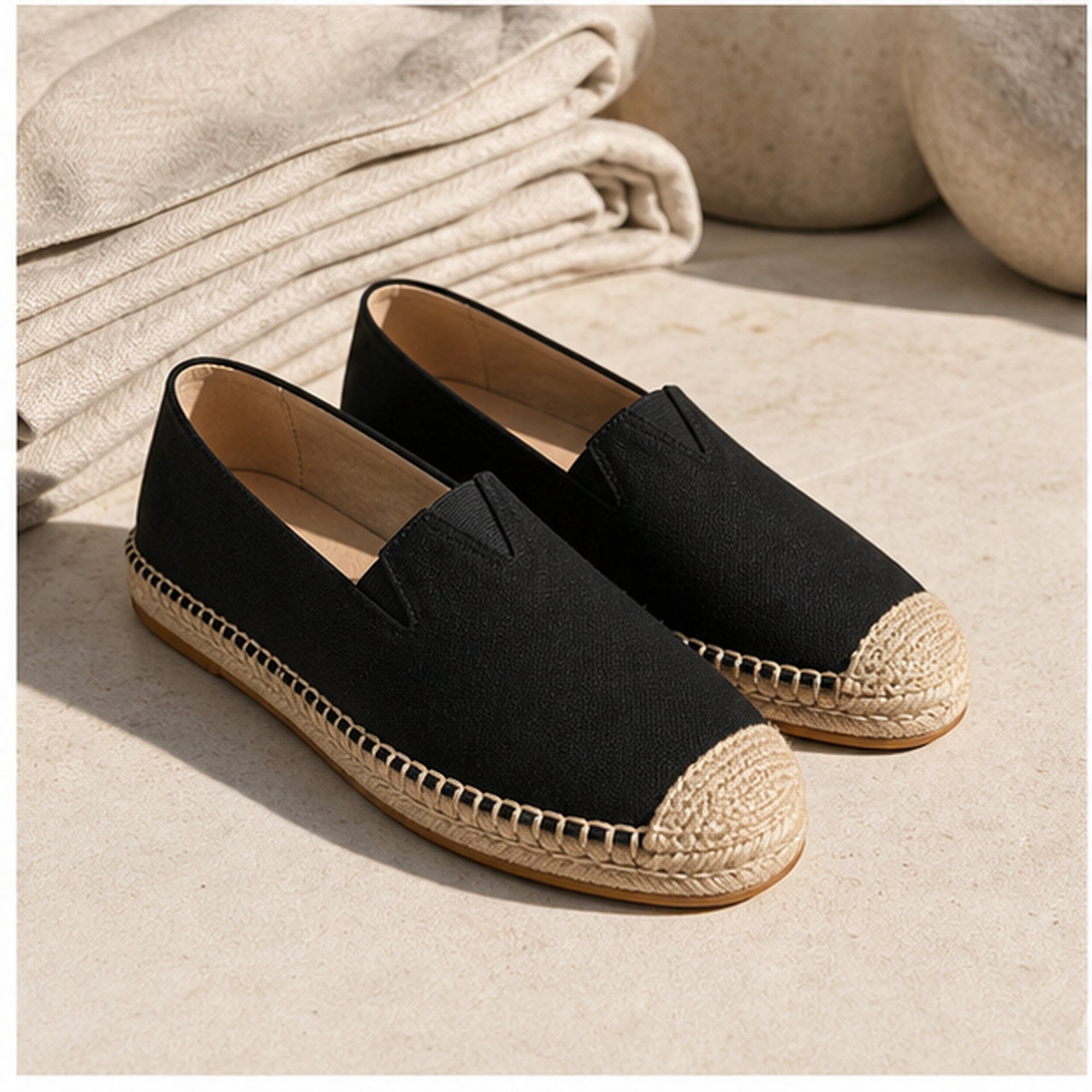 Black Wynmont canvas espadrilles with natural linen on pale stone
