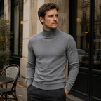 Man wearing the grey Yoremora turtleneck outside a European cafe