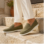 Green Zalemora suede loafers styled on Mediterranean stone steps
