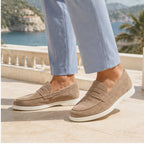Sand Zalemora suede loafers styled on a coastal hotel terrace